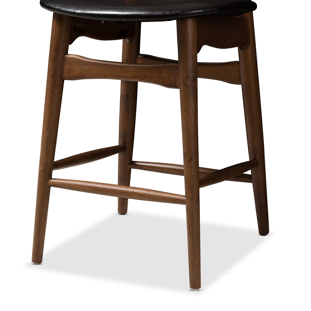 BAXTON STUDIO FLORA MID-CENTURY MODERN BLACK FAUX LEATHER UPHOLSTERED WALNUT FINISHED COUNTER STOOL (SET OF 2)