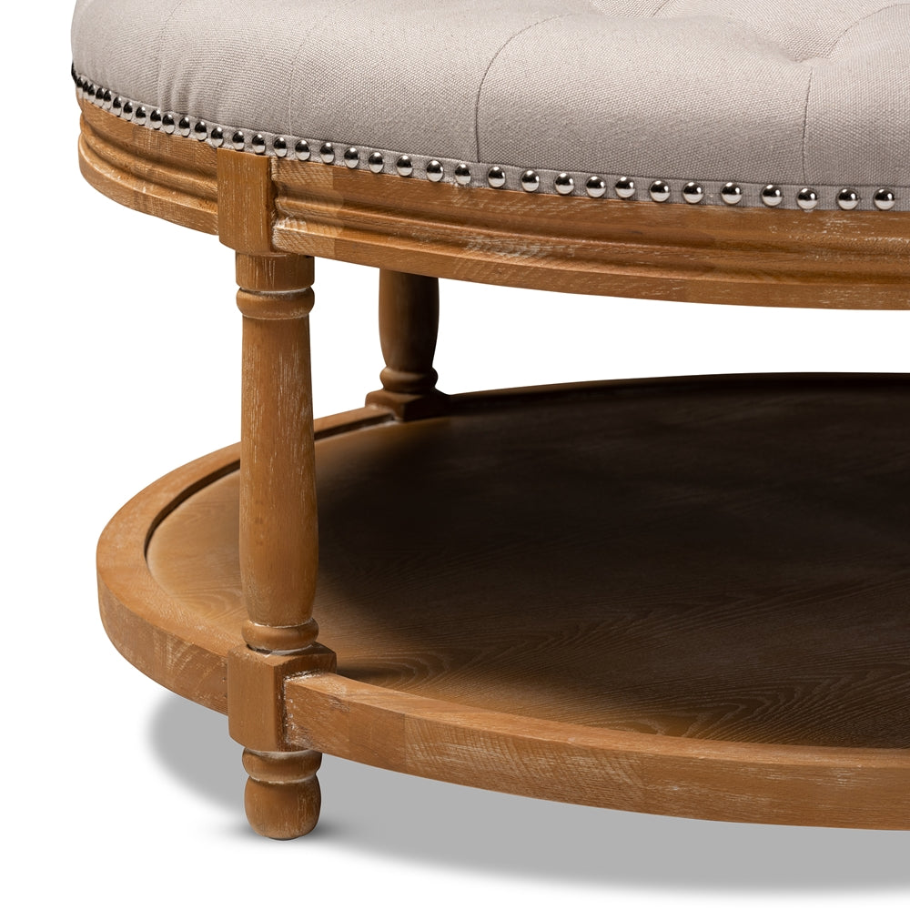 BAXTON STUDIO AMBROISE FRENCH PROVINCIAL BEIGE LINEN FABRIC UPHOLSTERED AND WHITE-WASHED OAK WOOD BUTTON-TUFTED COCKTAIL OTTOMAN WITH SHELF